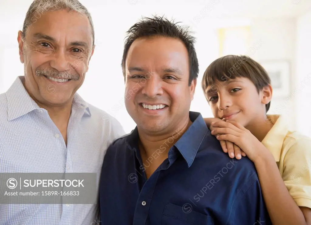 Smiling Hispanic grandfather, father and son