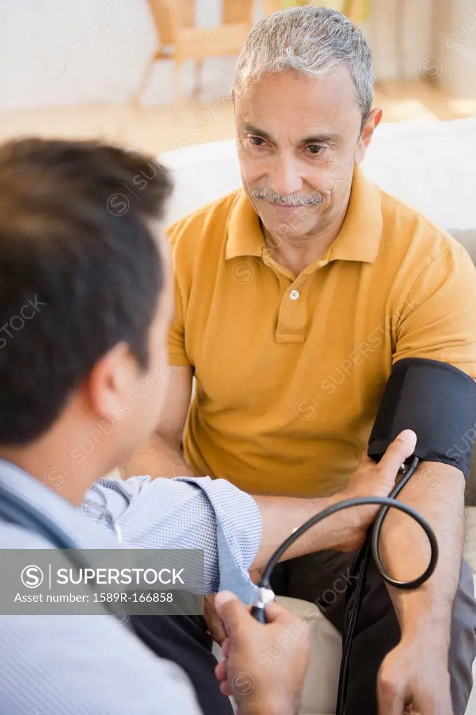 Hispanic man having his blood pressure taken
