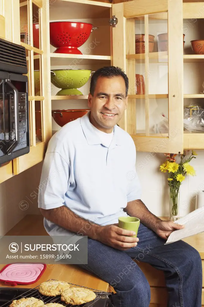 Man sitting on kitchen counter