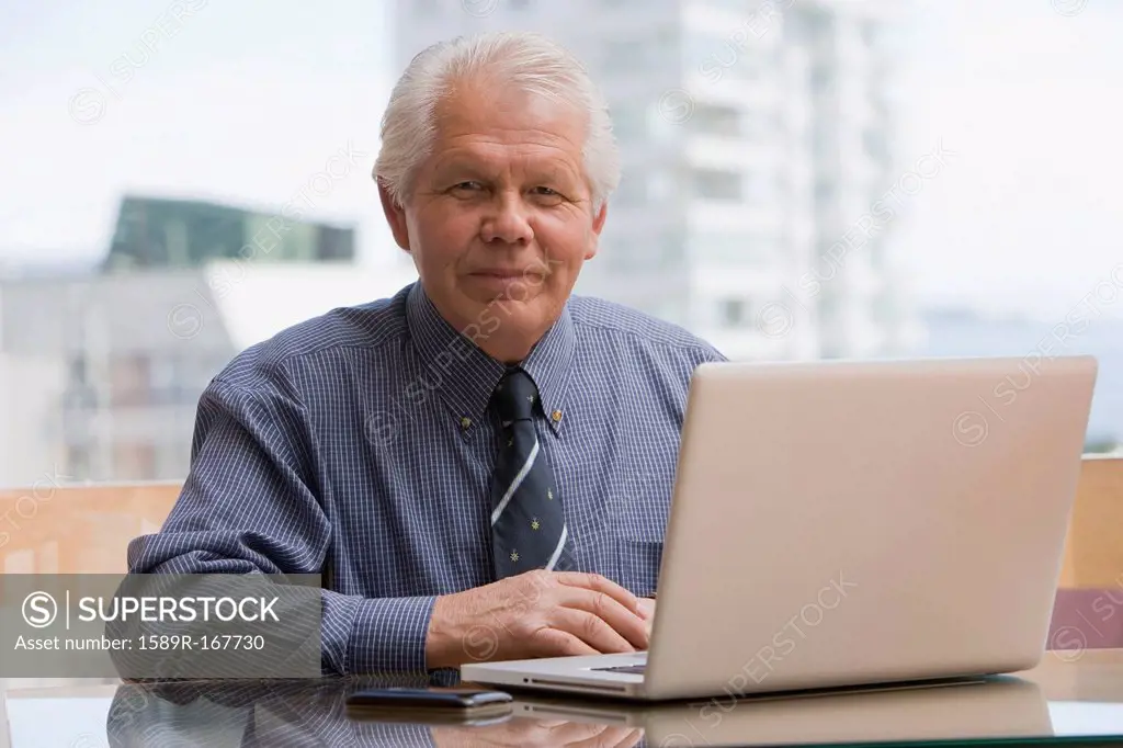 Chilean businessman sitting at desk with laptop