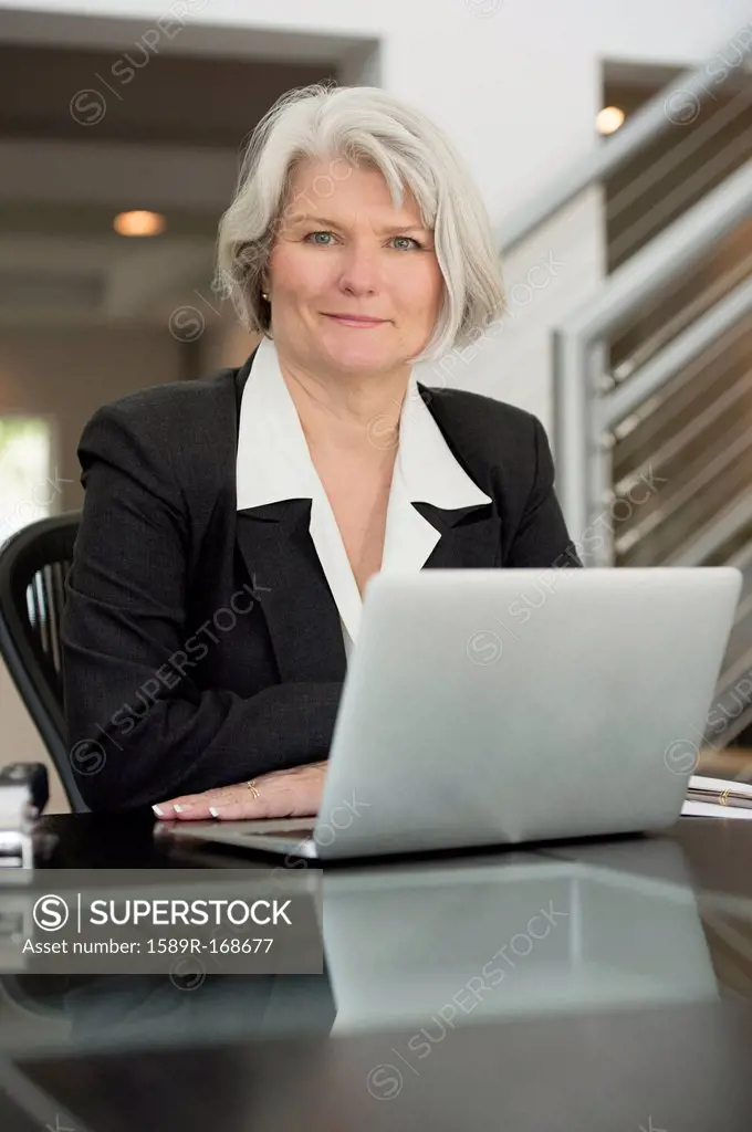 Businesswoman at desk with laptop