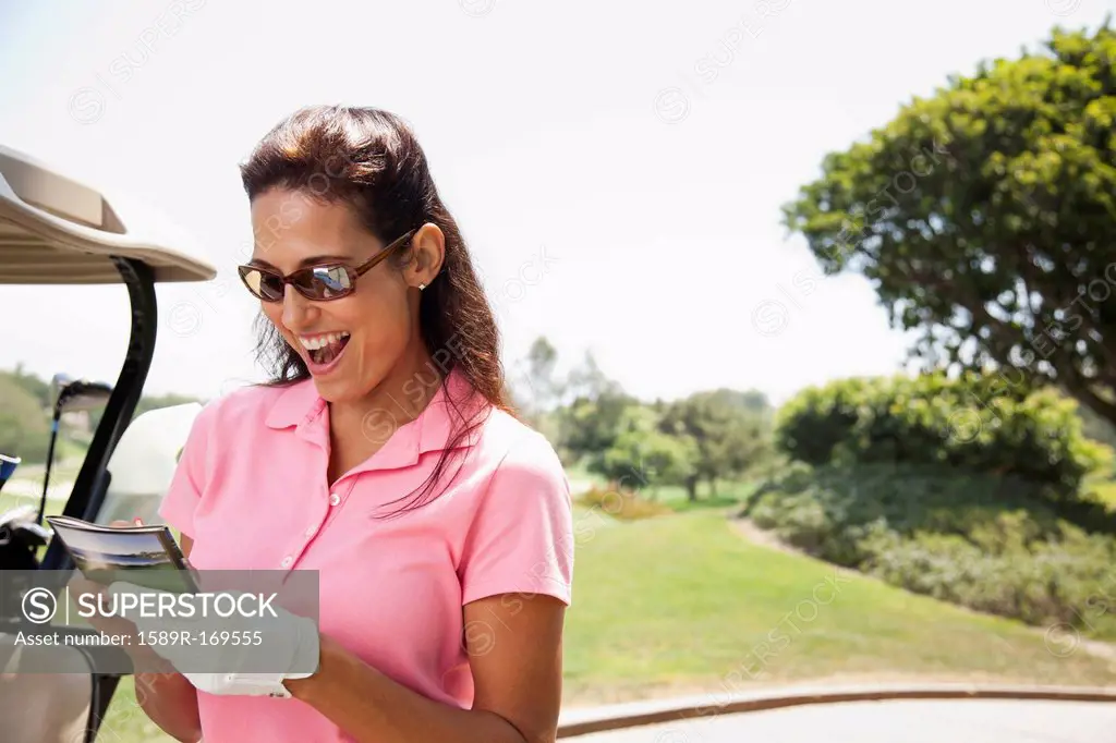 Woman keeping score during golf game