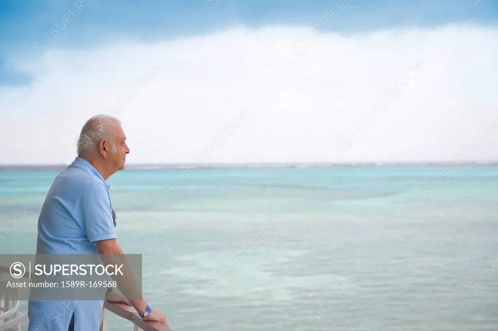 Hispanic older man overlooking ocean
