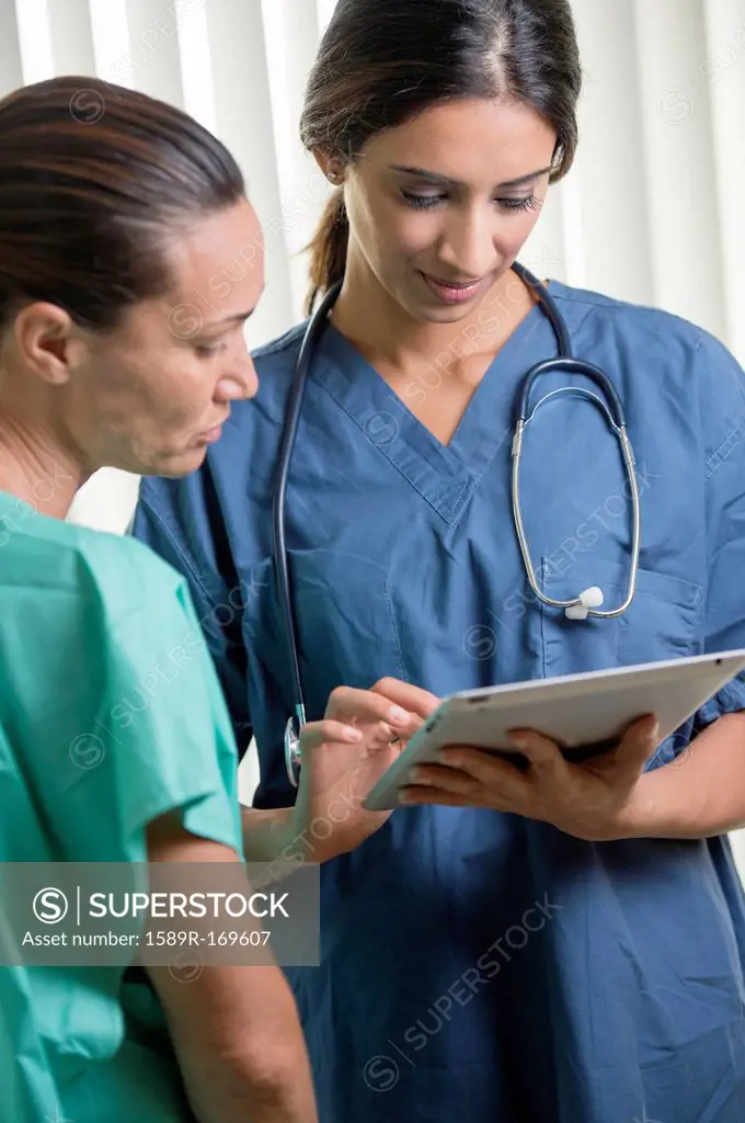 Nurses using tablet computer