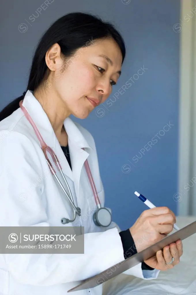Japanese doctor writing on clipboard