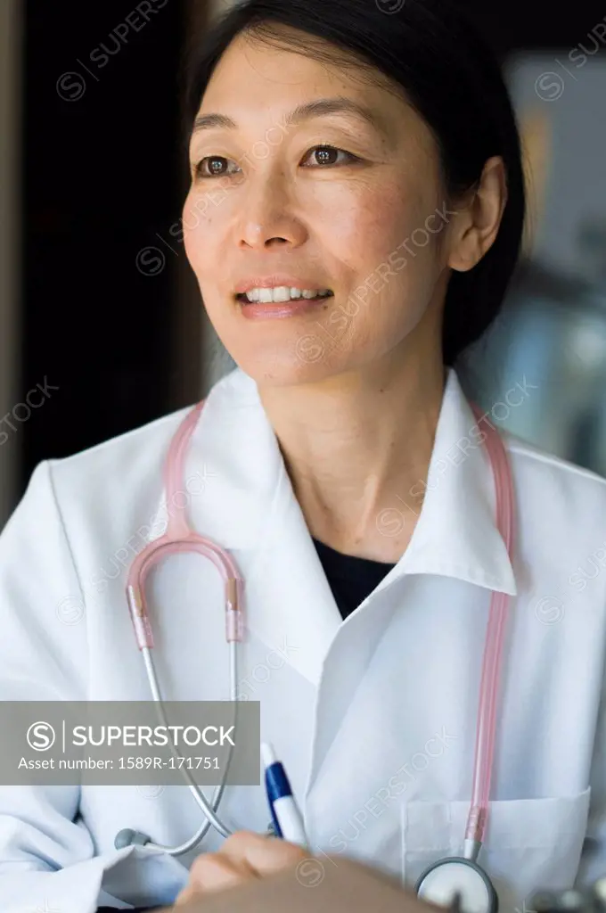 Japanese doctor writing on clipboard