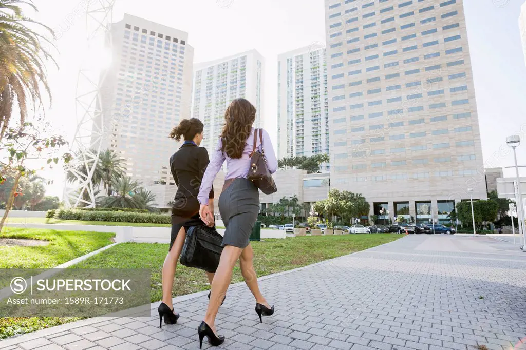 Hispanic businesswomen walking together