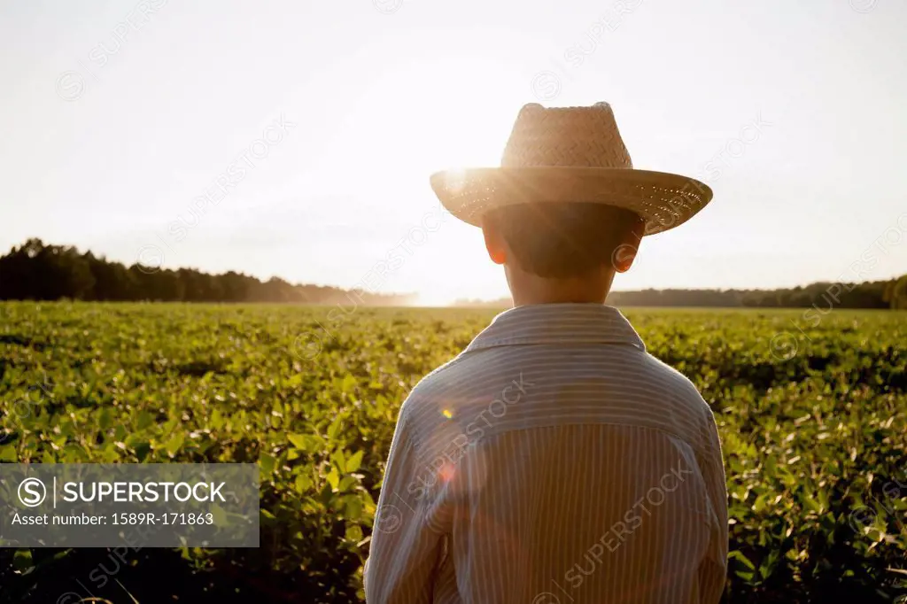 Caucasian boy overlooking rural field