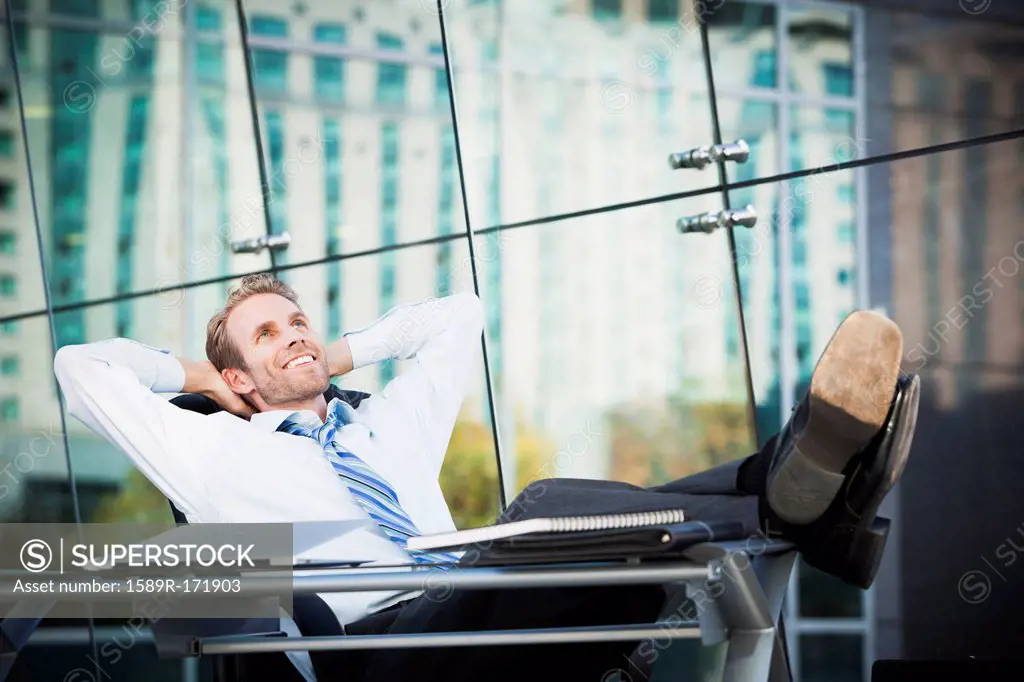 Caucasian businessman relaxing at desk