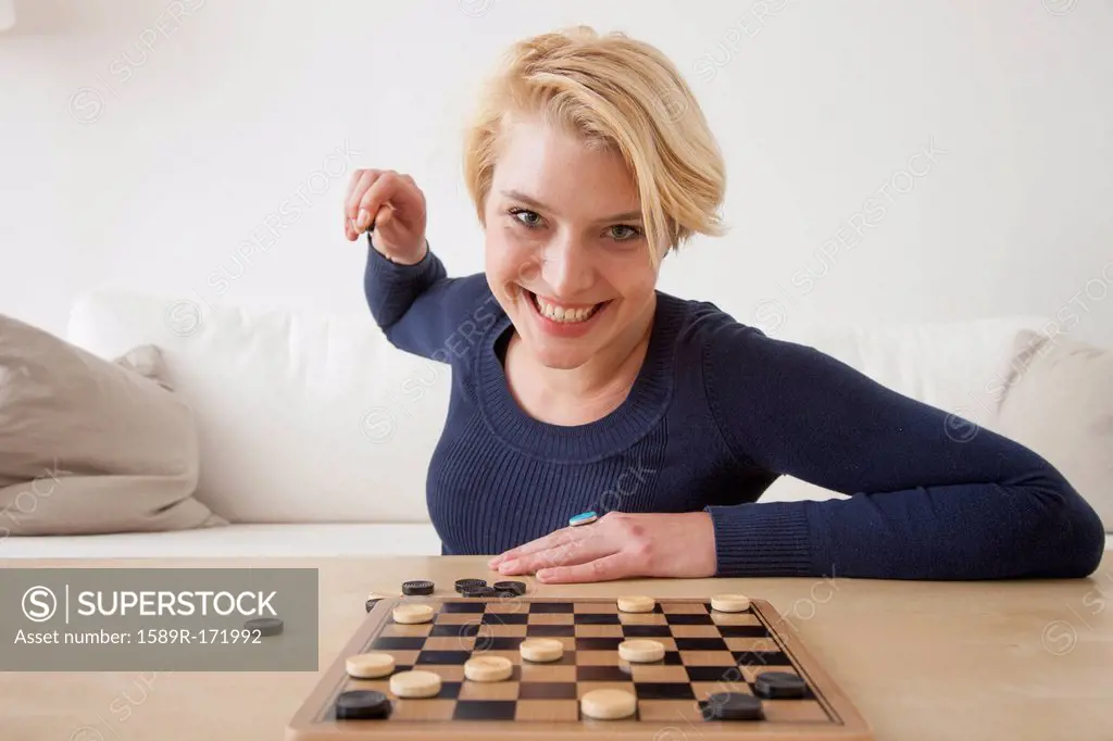 Caucasian woman playing checkers