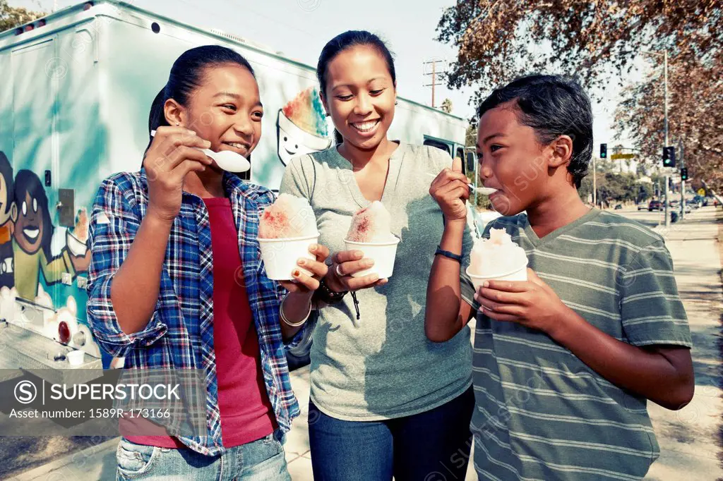 Family eating ice cream from truck