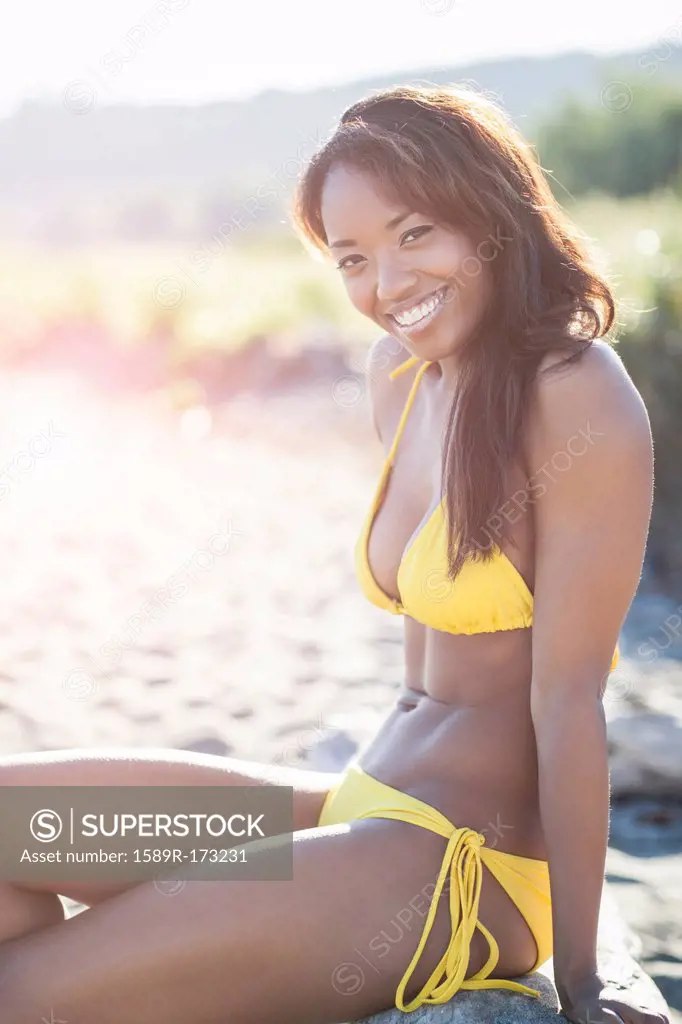 Mixed race woman in bikini on beach