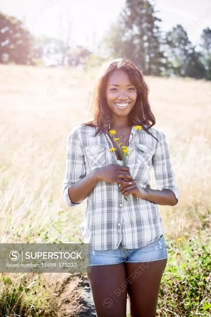 Mixed race woman standing in field
