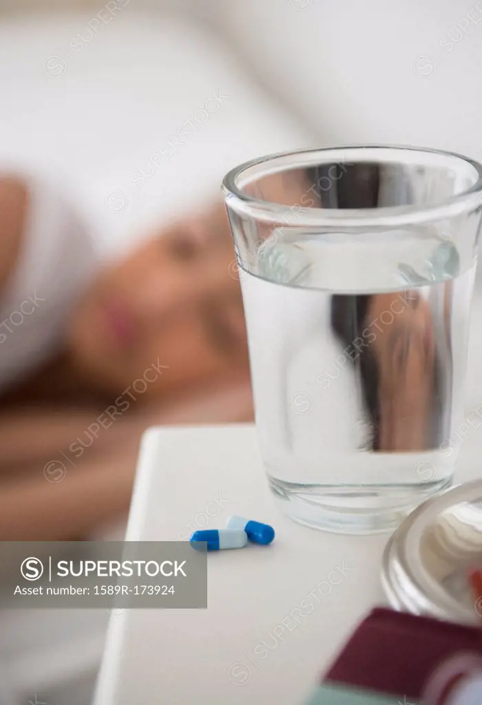 Close up of pills and water on bedside table