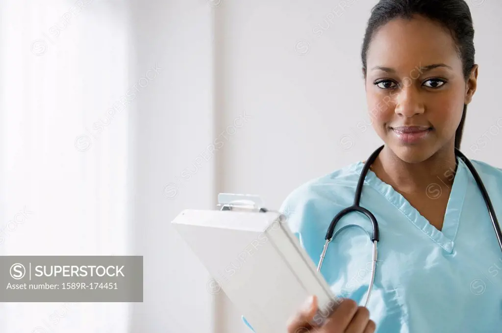 African American nurse holding clipboard