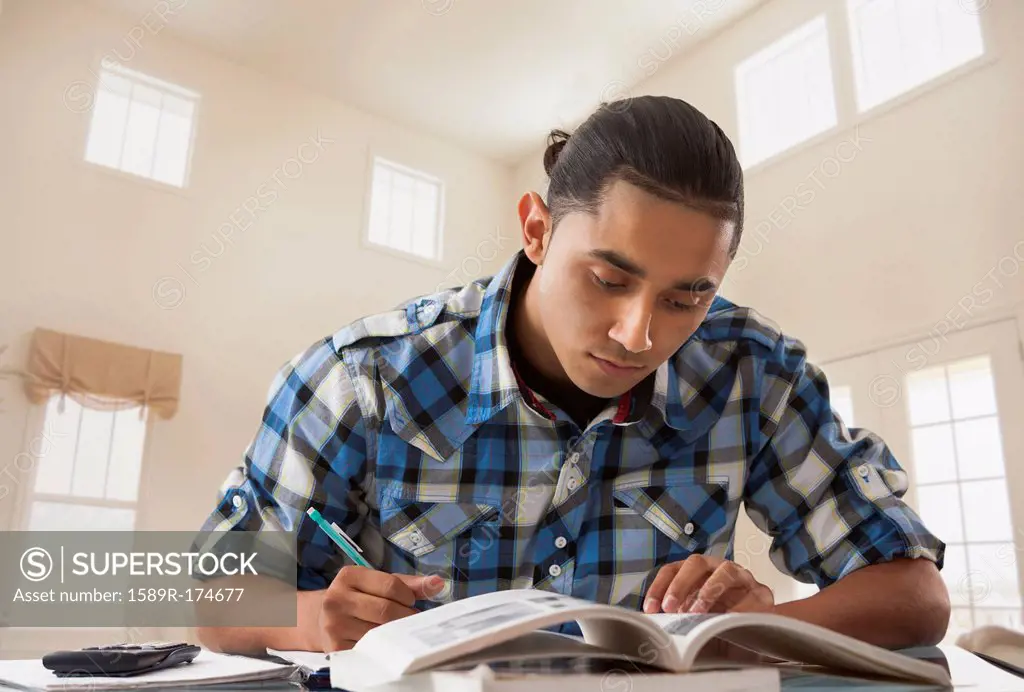 Hispanic man studying at desk