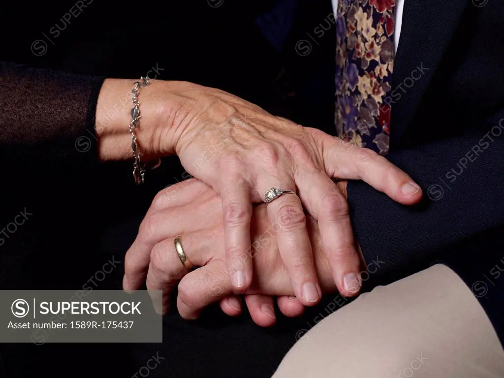 Close up of older couple's clasped hands