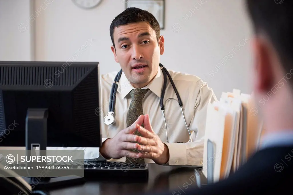 Doctor talking to clients in office