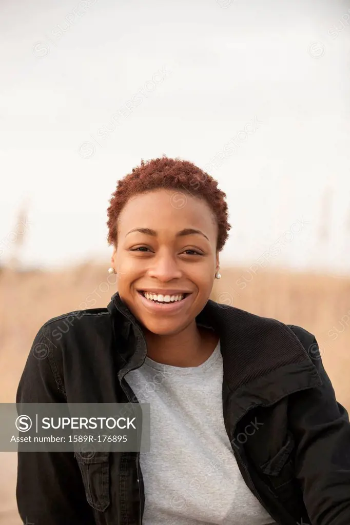 Smiling African American woman sitting outdoors