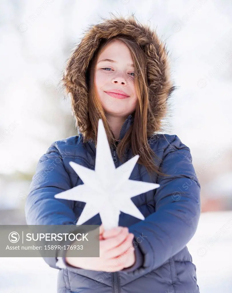Caucasian girl holding decorative star