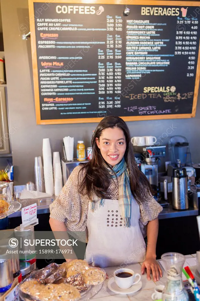 Mixed race woman working in coffee shop