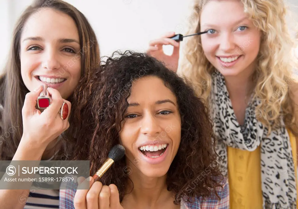 Women applying makeup together
