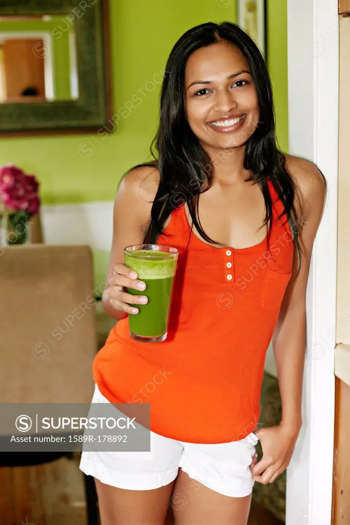 Indian woman having glass of juice
