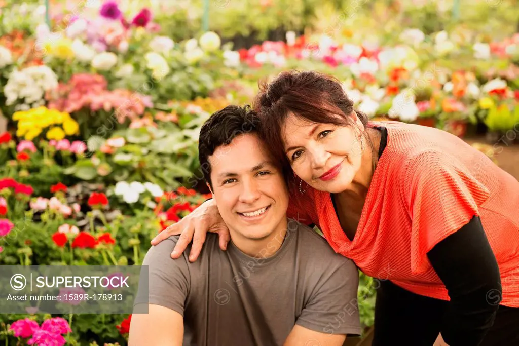 Hispanic couple smiling in field
