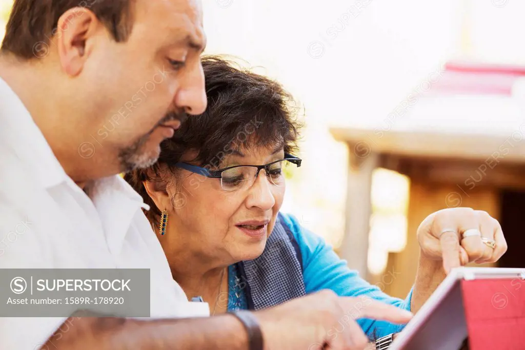 Hispanic mother and son reading together