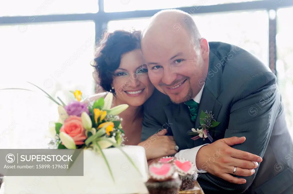 Hispanic couple smiling at wedding