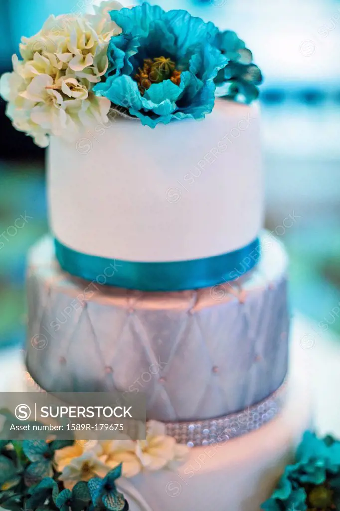 Blue and silver wedding cake with flowers