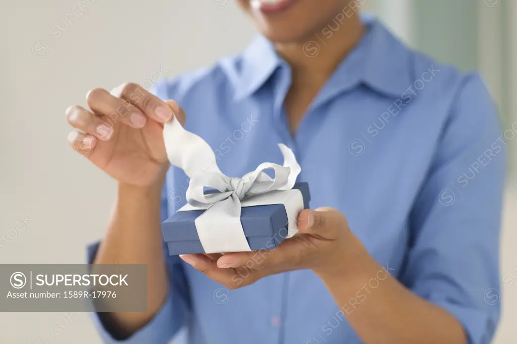 Close up of womanís hands opening gift