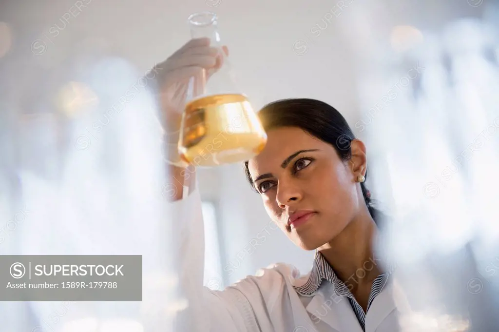 Indian scientist examining chemicals in lab