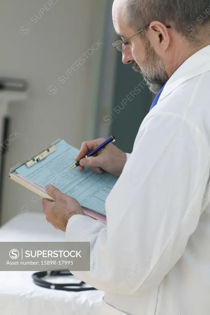 Doctor writing notes on clipboard