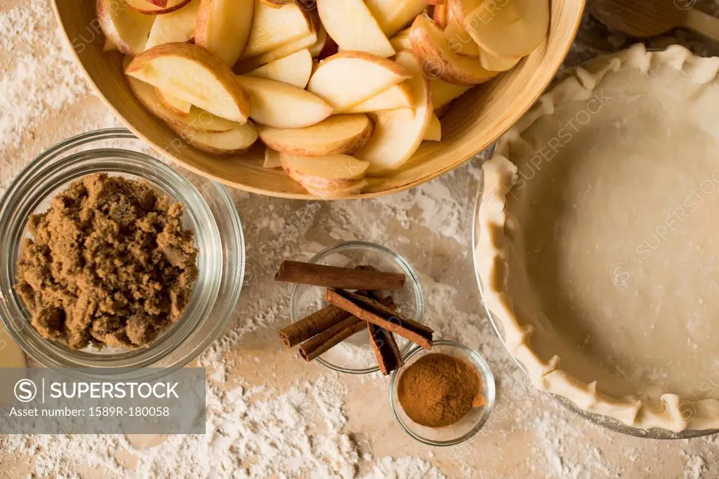 Close up of apples, spices and empty pie shell