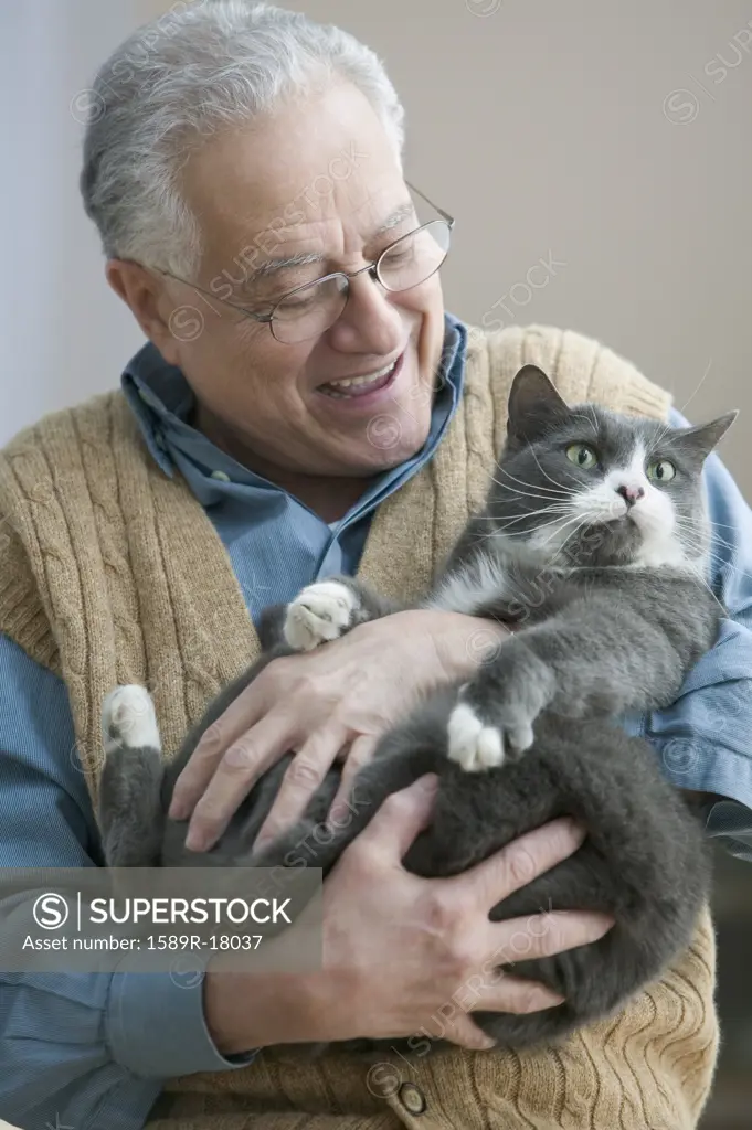 Older man holding his cat