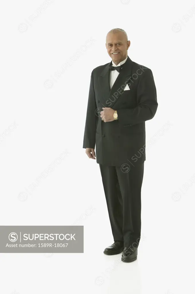 Full view portrait of man in tuxedo