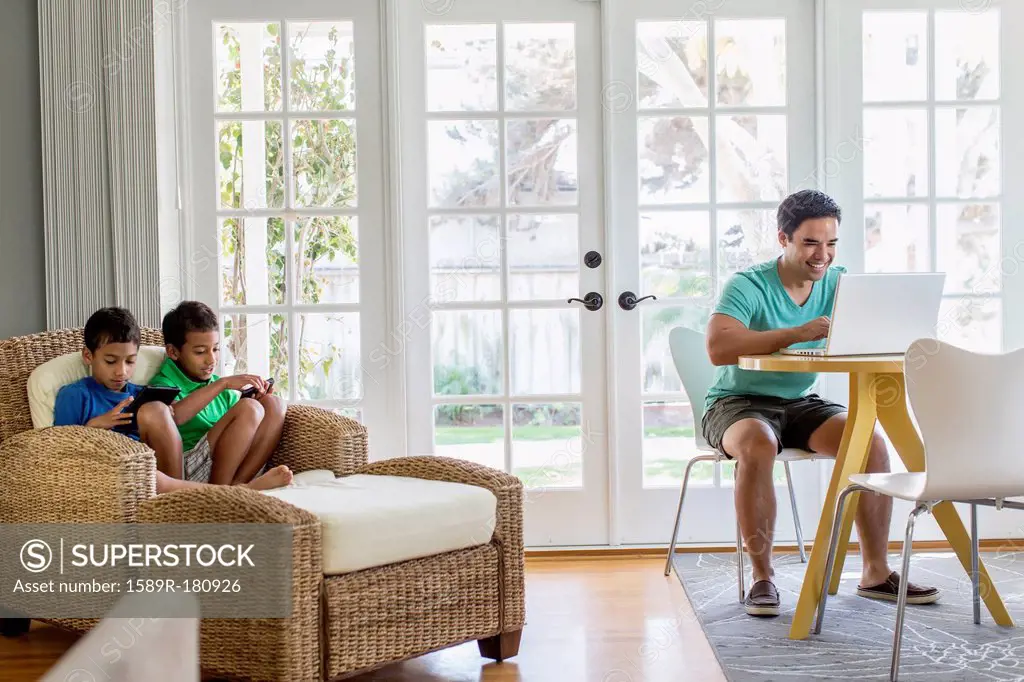 Hispanic family relaxing in living room