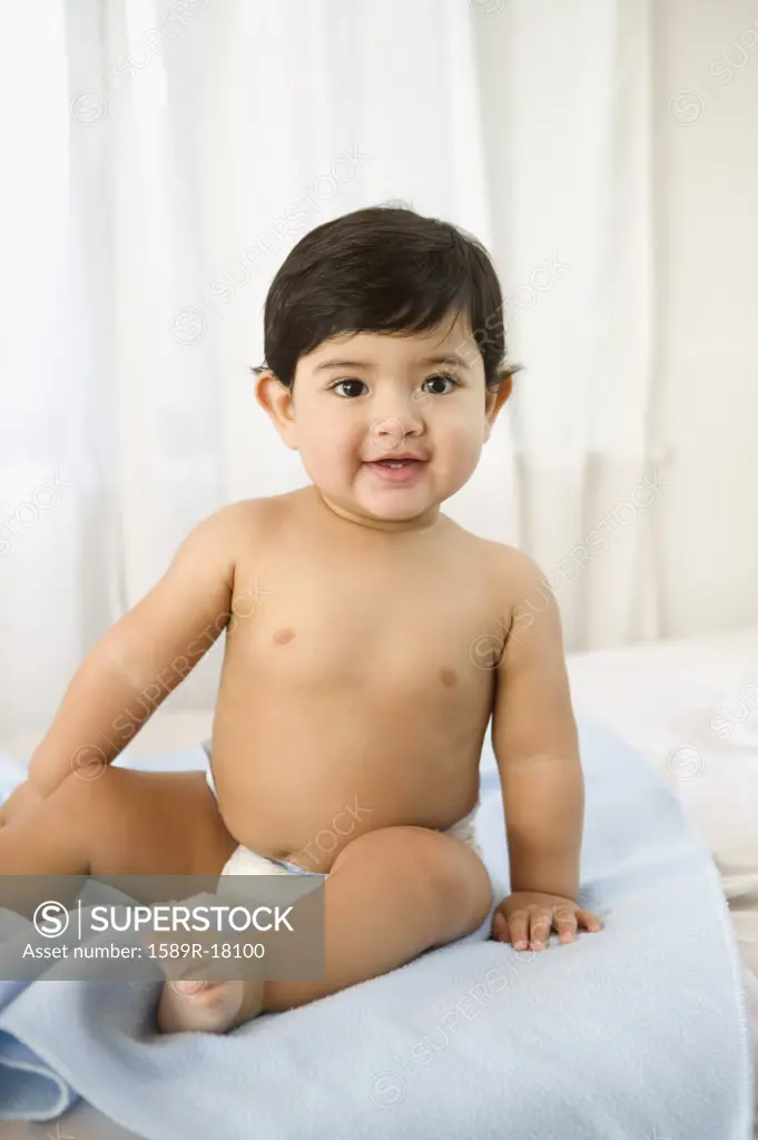 Portrait of toddler boy sitting in diaper