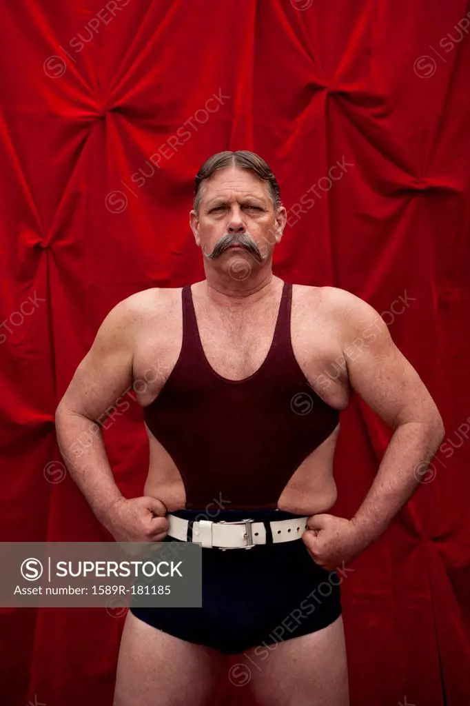Caucasian weight lifter flexing his muscles