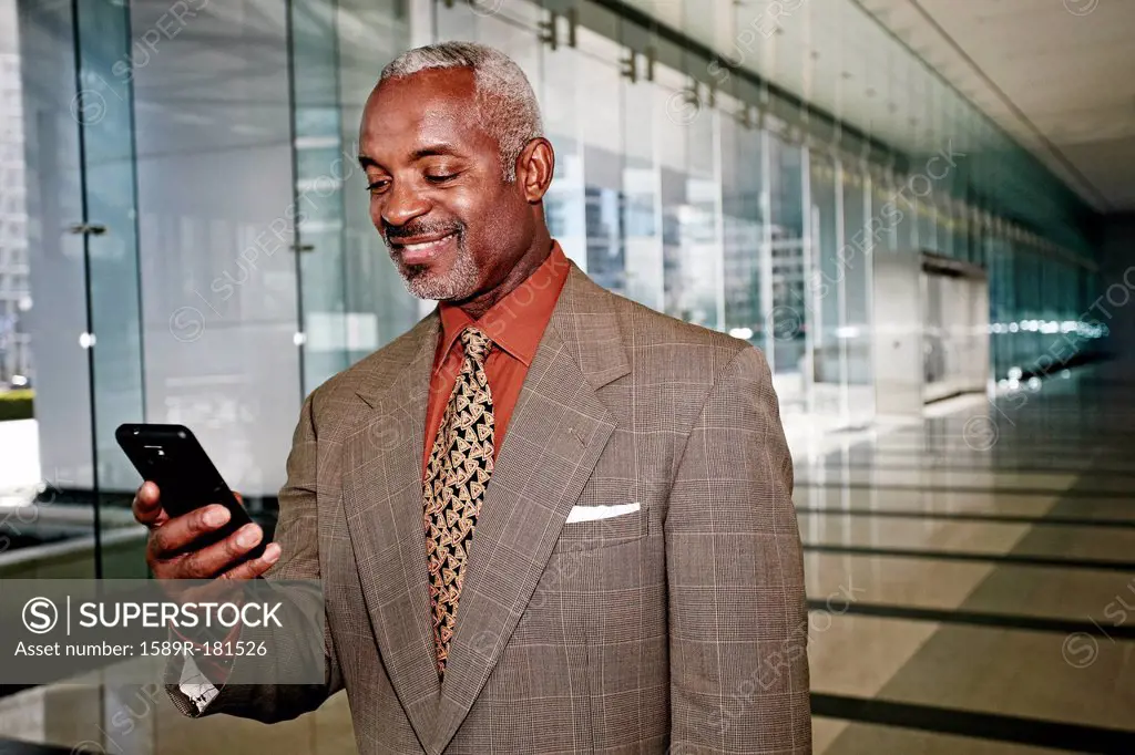 Black businessman using cell phone