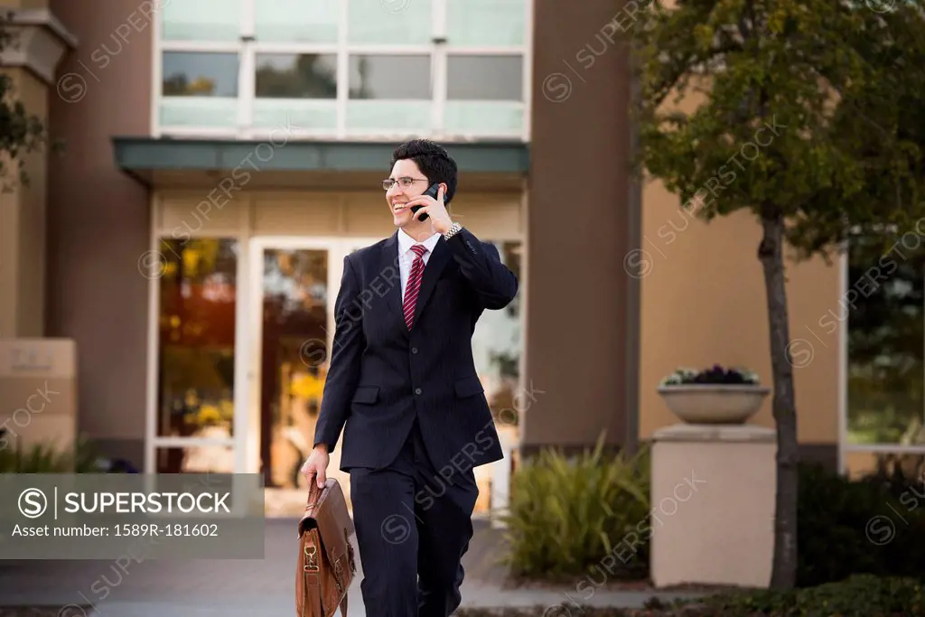 Hispanic businessman talking on cell phone