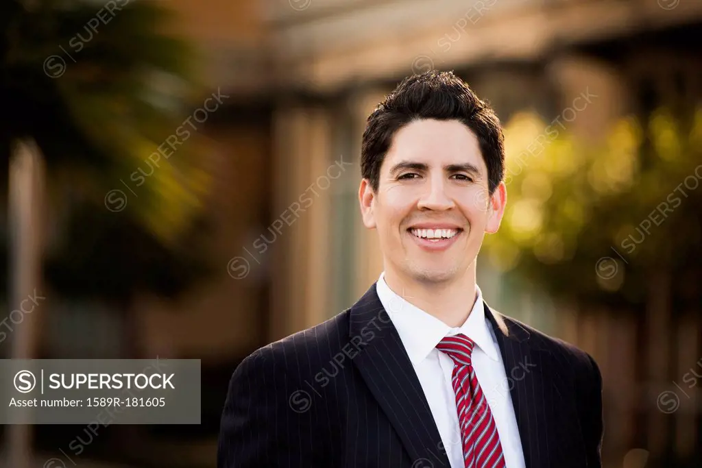Hispanic businessman smiling outdoors