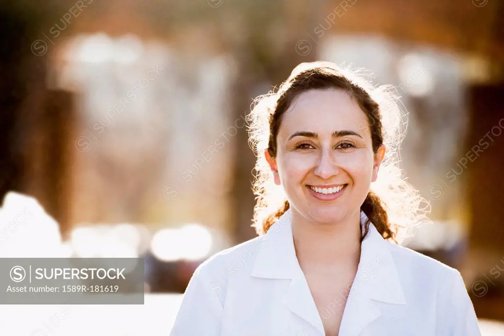 Hispanic doctor smiling outdoors