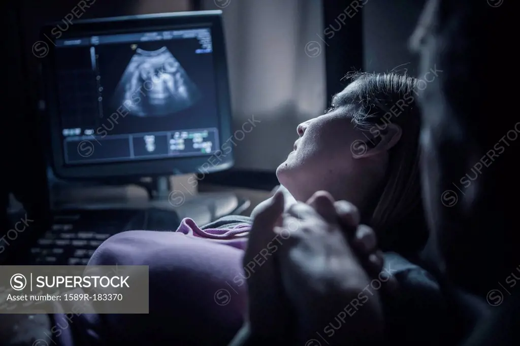Pregnant couple having sonogram