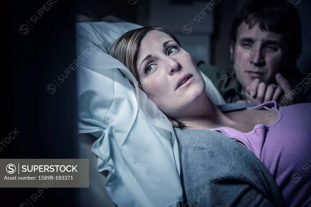 Worried couple in hospital bed