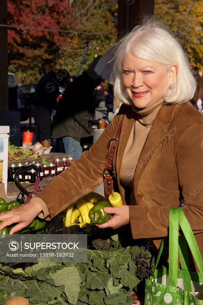 Older Caucasian woman shopping at farmer's market