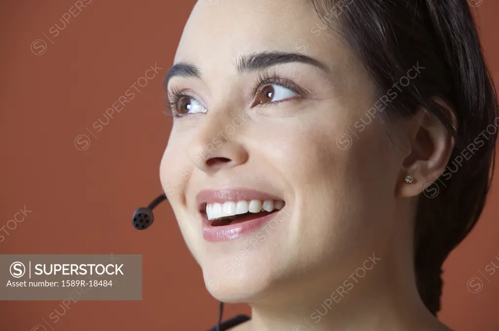 Woman with earpiece smiling