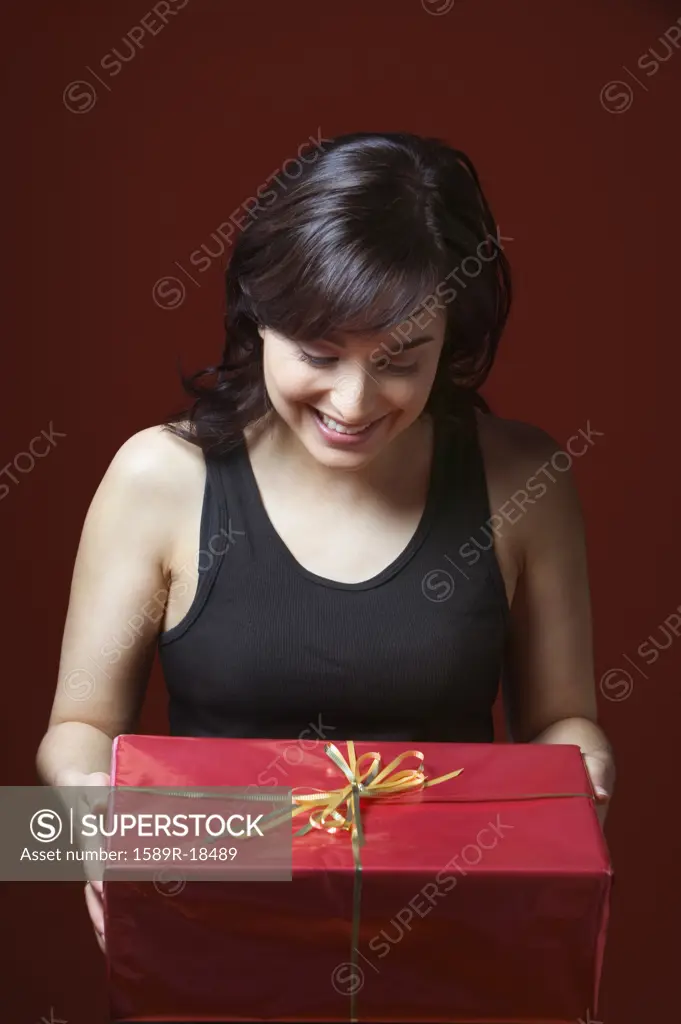 Woman holding gift looking down