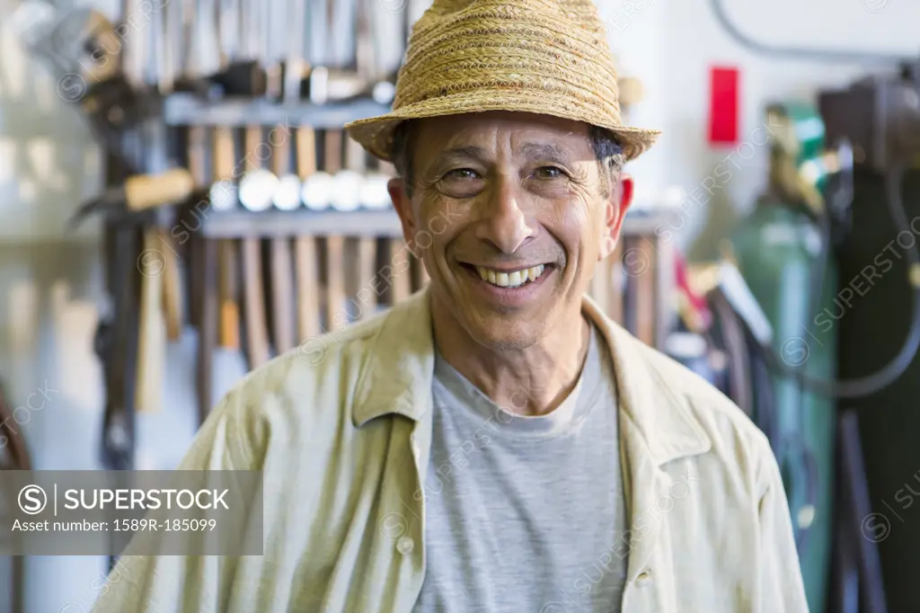 Middle Eastern man smiling in workshop